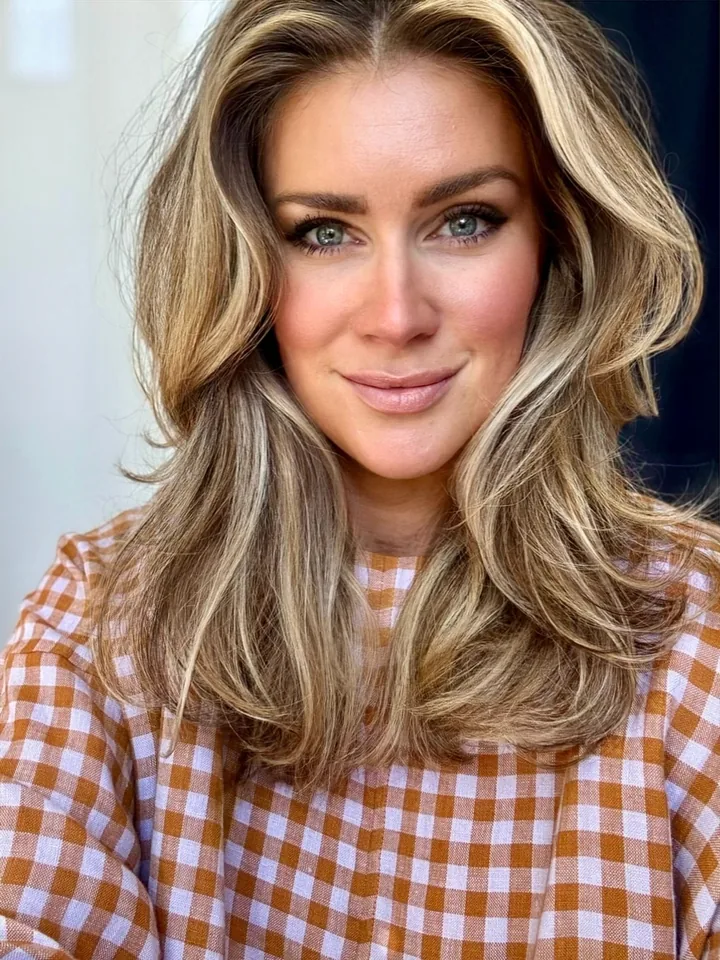 Brit Cooper Robinson, photographed close, in a rust and white gingham shirt.